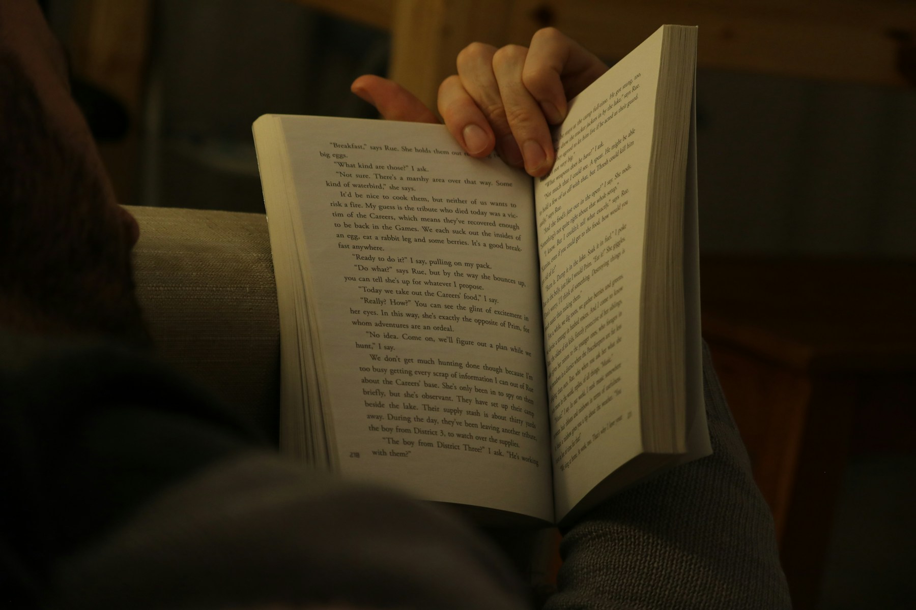 A person holding an open book and reading
